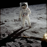 Astronaut Buzz Aldrin walks on the surface of the moon.